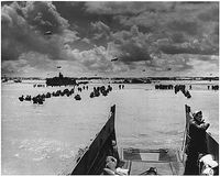 Dans les mâchoires de la mort.<br>Les Troupes U.S pataugeant dans l'eau sous le feu des allemands.(Franklin D. Roosevelt Library)